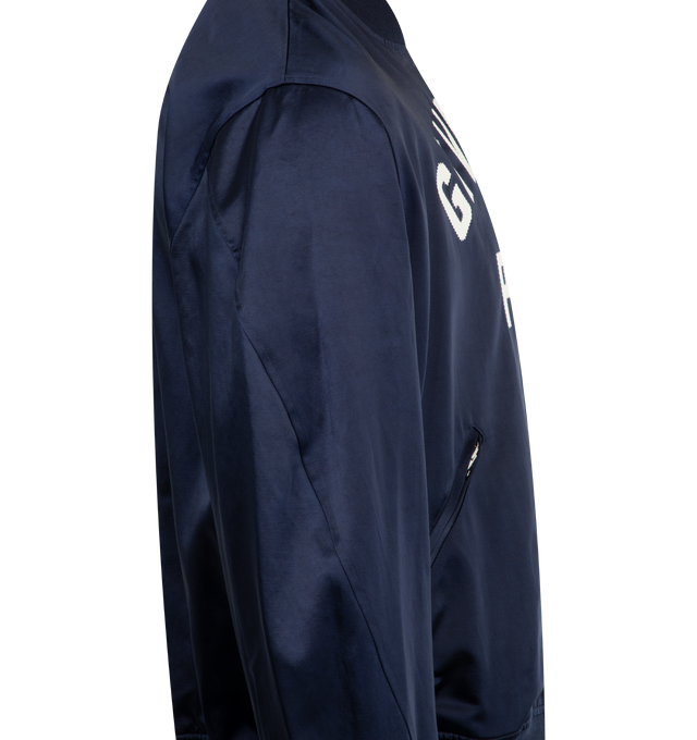 Image 3 of 3 - NAVY - GIVENCHY Paris Zipped Blouson in satin featuring bomber collar, GIVENCHY Paris gros grain patch with zigzag stitchings embroidered on the front, zipped closure, two zipped pockets, ribbed collar, hem and and cuffs and relaxed fit. 53% cotton, 47% acetate. Lining: 100% cotton.