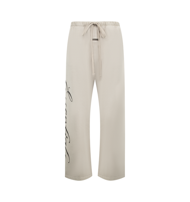 Image 1 of 4 - GREY - FEAR OF GOD ESSENTIALS Heavy Fleece Lounge Sweatpant featuring 520gsm heavy fleece treated with a pigment dye to create rich depth of color, wide-leg silhouette, bold Essentials script logo on the leg, encased elastic waistband with elongated drawcords, side seam pockets and a Fear of God Essentials rubberized label stitched at the center front. 100% cotton.