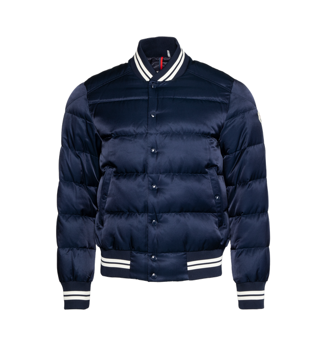 Image 1 of 3 - NAVY - MONCLER Dives Down Bomber Jacket featuring recycled longue saison lining, down-filled, embroidered logo lettering and logo, zipper and snap button closure, external pockets with snap button closure, zipped internal pocket and striped ribbed hem, collar and cuffs. Exterior: 58% cotton, 42% viscose/rayon. Lining: 100% polyamide/nylon. Padding: 90% down, 10% feather. Embroidery: 100% polyester. Ribs: 85% polyester, 13% polyamide/nylon, 2% elastane/spandex. Made in Romania. 