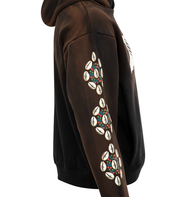 Image 3 of 3 - BLACK - BARRIERS Cowrie Shell Hoodie featuring 500 GSM french terry, hidden pocket, garment dyed, front graphic with cracked distress print and cowrie sleeves in puff print for 3D effect. 100% cotton.