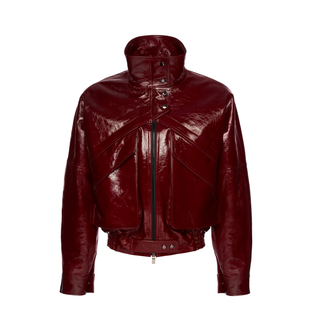 Image 1 of 2 - RED - Magda Butrym oversized patent leather bomber jacket featuring sloping shoulders, a cinched elastic waistband, zip and button closures, and oversized front flap pockets. Shell 100% Sheep Leather. Lining 100% Viscose. Made in France.