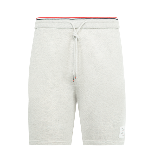 Image 1 of 3 - GREY - THOM BROWNE Pique Loopback Sweat Shorts featuring french terry shorts, drawstring at striped rib-knit waistband, three-pocket styling and logo patch at front cuff. 100% cotton. Made in Japan.