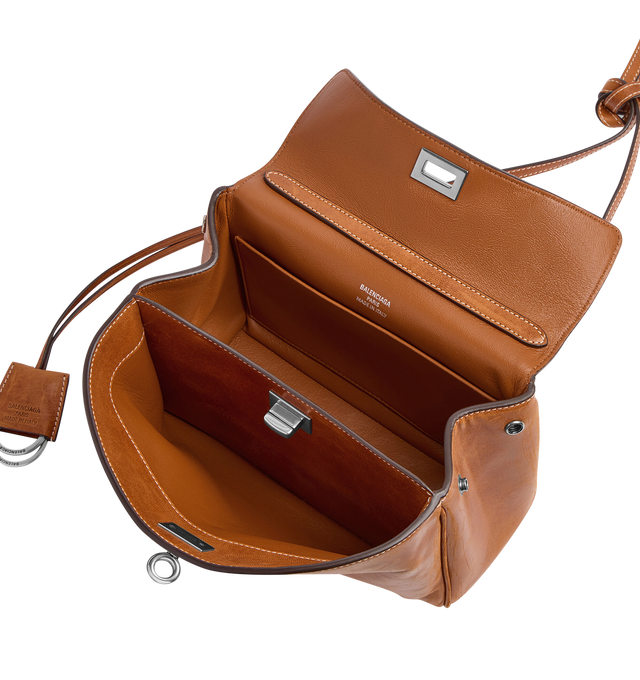 Image 4 of 4 - BROWN - BALENCIAGA Rodeo Handbag Mini featuring vegetal tanned lambskin, one handle hand carry, adjustable and removable crossbody strap, removable cloche cls with two split rings, aged-silver hardware, turn lock closure, wide front pocket, 1 main compartment, 2 flat pockets at back, side snaps, 4 brass feet and nappa lambskin lining. Lambskin. Made in Italy.