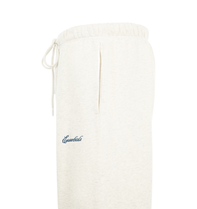 Image 3 of 3 - WHITE - Fear of God ESSENTIALS Men's Signature Flare Sweatpant is crafted from heavyweight 380 GSM cotton-blend fleece and features a relaxed-fit silhouette that extends into a flared leg. Designed with the Essentials signature logo embroidered at the leg, this elevated loungewear style is finished with an encased elastic waistband, elongated drawcords, side-seam pockets, and a signature Essentials label at the center front. Main Material: 80% Cotton, 20% Polyester, 380 GSM.