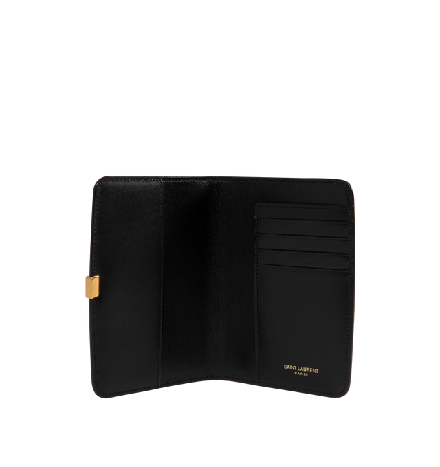 Image 3 of 3 - BLACK - Saint Laurent VOLTAIRE passport holder with inner card slots, decorated with the CASSANDRE. Featuring leather lining, bronze-toned hardware, two flat pockets, five card slots. Measures 5.3" x 3.9" x 0.8". Made in Italy.