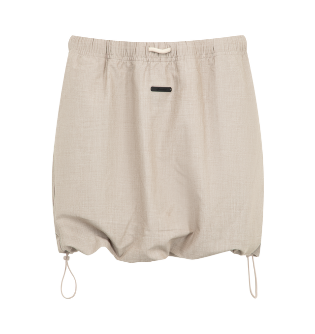 Image 1 of 3 - NEUTRAL - The Fear Of God Essentials Women's Micro Skirt is crafted from a silk stretch blend for elevated comfort. This mini silhouette features an encased elastic waistband with bungee drawcords and adjustable toggles at the waist and hem. Materials: 69% Polyester, 19% Silk, 8% Wool, 4% Spandex.