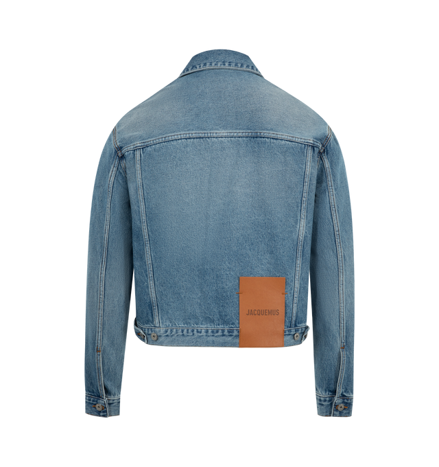 Image 2 of 3 - BLUE - JACQUEMUS Denim Jacket featuring straight cut, washed indigo denim, pointed collar, engraved metal buttons, denim patch pockets, buttoned cuffs, front and back yoke, buttoned tab on the back hem, silver hardware, large denim patch and contrast stitching. 100% cotton. Made in Portugal.