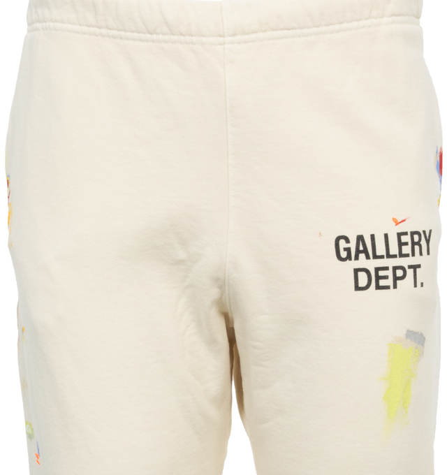 Image 3 of 4 - WHITE - GALLERY DEPT. LOGO SWEATPANTS featuring tapered leg, low-crotch style, elasticated at the waist and hem, paint splatter and logo on leg. 100% cotton. 