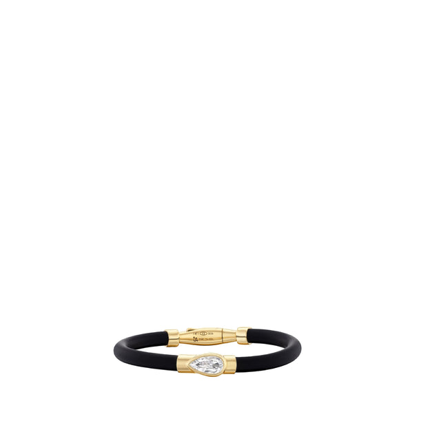 Image 1 of 3 - GOLD - Uniform Object Carbon Bracelet featuring 14 g of 18K yellow gold with a 1.01 ct pear brilliant diamond and 0.20 TCW round diamond accents. Handcrafted in New York City. Features an Italian-made hypoallergenic rubber band designed for comfort and durability. Hirshleifers offers a range of pieces from this collection in-store. For personal consultation and detailed information about jewelry, please contact our dedicated stylist team at personalshopping@hirshleifers.com.