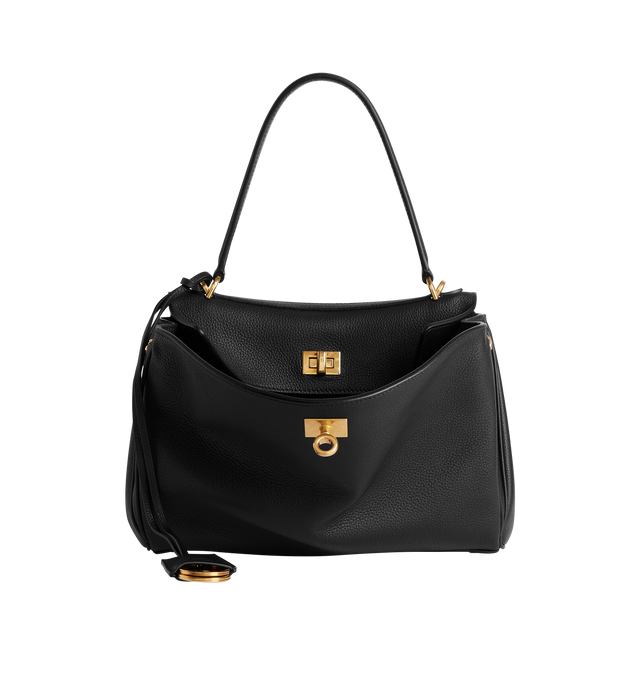 Image 1 of 4 - BLACK - BALENCIAGA Rodeo Handbag Small featuring smooth calfskin, one handle, removable shoulder strap, removable cloche cls with two split rings, aged-gold hardware, turn lock closure, wide front pocket, 1 main compartment, 1 inner zipped pocket, 2 flat pockets at back, side snaps, 4 brass feet and nappa lambskin lining. Calfskin. Made in Italy.