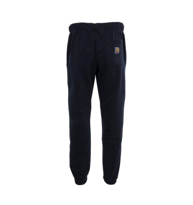 Image 2 of 5 - NAVY - CARHARTT WIP Class of 89 Sweat Pant featuring loose fit, pigment-dyed, adjustable waistband, two side pockets, one rear pocket, graphic print and square Label. 84% cotton, 16% polyester. 