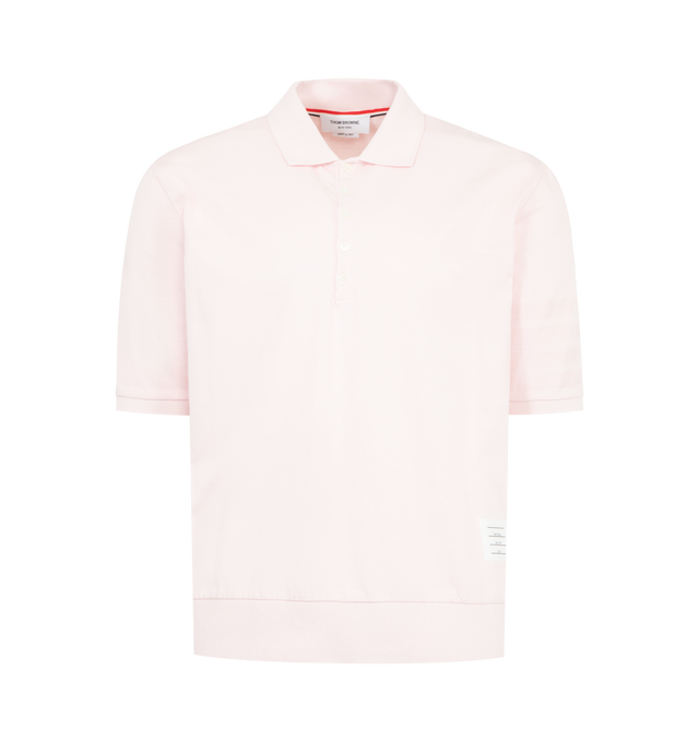 Image 1 of 3 - PINK - THOM BROWNE Garment Overdyed Jersey 4 Bar Polo featuring partial front button closure, ribbed collar, sleeve cuffs, and hem, overdyed 4-bar detailing, name tag appliqu, signature striped grosgrain loop tab and garment dyed. 100% cotton. Made in Italy.