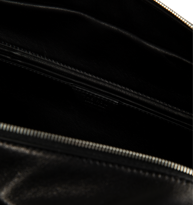 Image 3 of 3 - BLACK - The Row Women's Astra Bowling Bag is crafted from glossy nappa lambskin leather and features a soft bowling bag silhouette with elongated flat handles, turned-edge construction, and a dual zip-top closure. Designed for everyday versatility, this refined carryall is fully lined in lambskin leather and offers ample space for daily essentials while maintaining a sleek, understated profile. Main Material: 100% Lambskin Leather. Lining: 100% Lambskin Leather. Dimensions: 11.81 x 3.94 x 7.0