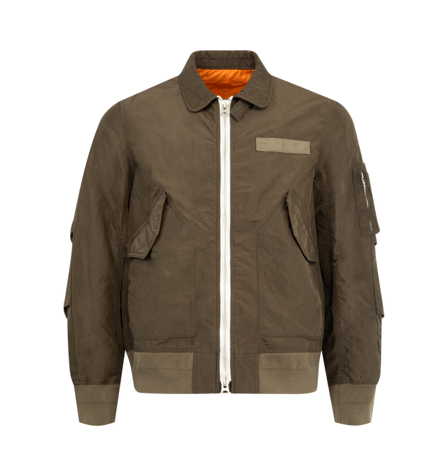 Image 1 of 3 - GREEN - SACAI Treated Nylon Twill Blouson featuring rib-knit hem and cuffs, two-way zip closure, flap pockets at front, utility pocket at sleeve and lined. 100% nylon. Lining: 100% polyester.