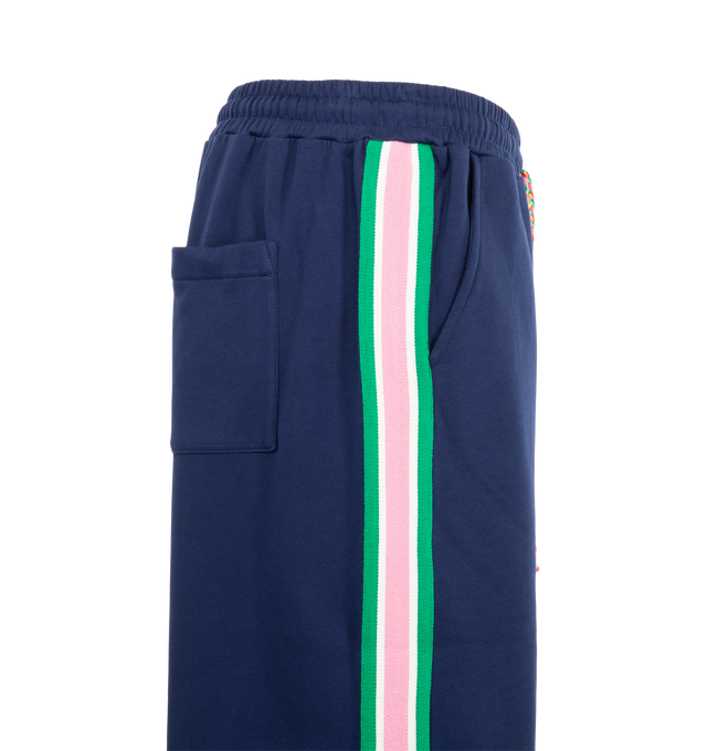 Image 3 of 3 - NAVY - Mira Mikati Women's Striped Rib Jogger with Contrast Poppers is crafted from organic cotton brushback fleece and features a wider, relaxed-fit silhouette designed for elevated everyday comfort. Finished with functional poppers along custom striped rib side panels, an elasticized waistband, and a signature plaited drawcord, this contemporary jogger blends sporty detailing with the brand's playful design aesthetic. Main Material: 100% Organic Cotton.
