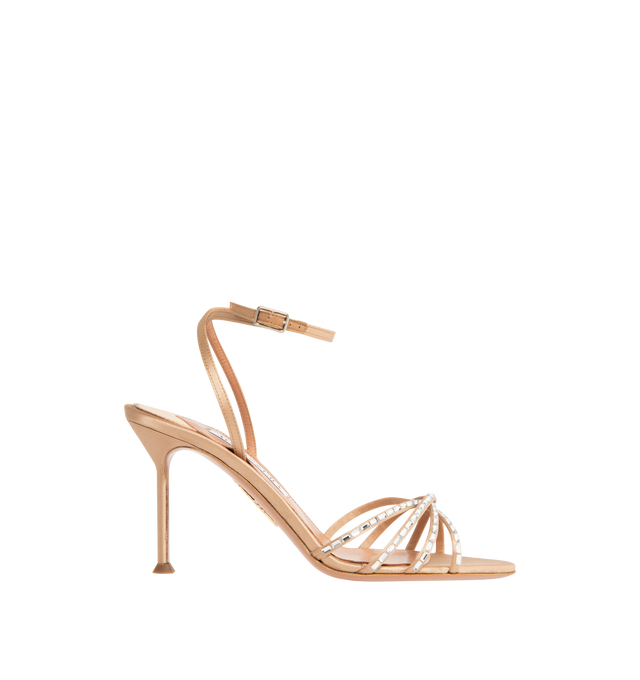 Image 1 of 4 - NEUTRAL - AQUAZZURA Tell Me Crystal Sandal 85 featuring adjustable buckle closure, gemstones that trace the caged design framing the toes, slim stiletto mid heel, padded leather insole and signature logo detailing. Satin. 85mm heel. Made in Italy.