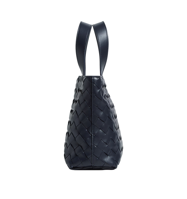 Image 2 of 3 - NAVY - BOTTEGA VENETA Mini Intrecciato Zipped Tote featuring mini Intrecciato leather zipped tote bag with adjustable and detachable cross-body strap, one external hidden pocket with magnetic closure, one interior zipped pocket and two flat open pockets and zipper closure. Calfskin. Lining: canvas. 7.1" x 10.6" x 3.9". Made in Italy.