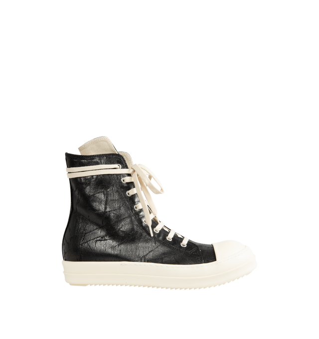 Image 1 of 5 - BLACK - Rick Owens DRKSHDW Men's Sneaks are crafted from 13 oz Megacrust Japanese denim and feature an above-ankle silhouette with eight eyelets, lace-up fastening, an interior ankle zipper, toe caps, and signature shark-tooth soles. Finished with a distinctive Megacrust treatment, the denim is overdyed black, wax-coated, and layered with black foil that naturally cracks and peels over time, creating a uniquely worn appearance with continued wear. Main Material: Upper 100% Cotton. Toe: 70% Po