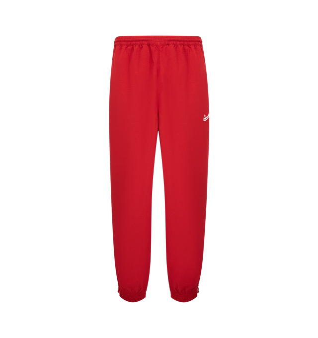 Image 1 of 3 - RED - WILLY CHAVARRIA Bad Boy Track Pants featuring elastic waistband with interior drawstring, side seam pockets, elastic hem and lightweight ripstop fabric with embroidered logo on left side. 100% nylon. Made in USA.