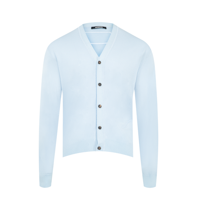 Image 1 of 2 - BLUE - JACQUEMUS The J Cardigan featuring relaxed fit, merino wool jersey knit, ribbed collar, cuffs and hem, long sleeves, embroidered J on the side, overlock stitching, embroidered Calisson patch on the back and horn buttons. 96% Merino wool, 4% polyamide.