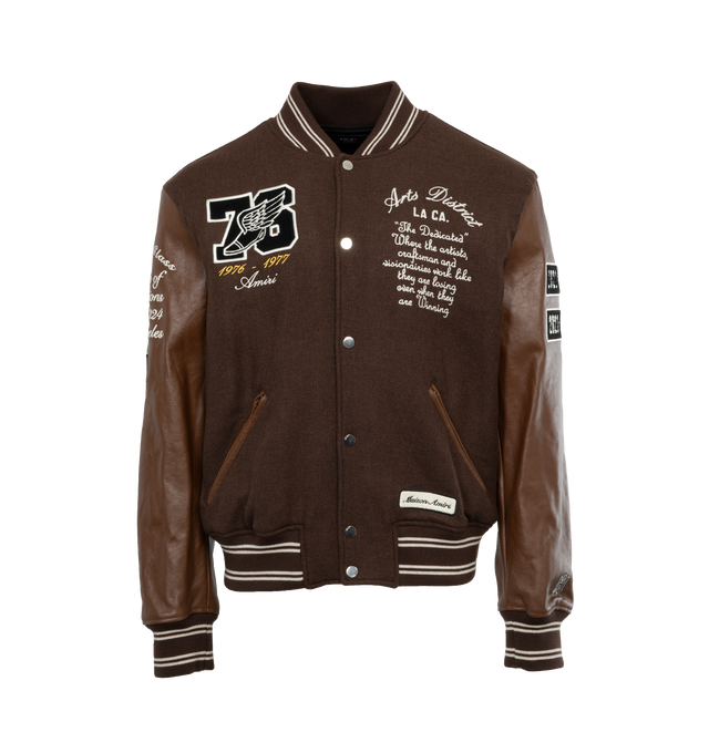 Image 1 of 4 - BROWN - AMIRI Oversized Eagle Varsity Jacket featuring front snap button closure, varsity inspired patches and side zipper pockets. 75% wool, 25% nylon. Lining: 100% viscose. Trim: 100% leather. Made in Italy. 