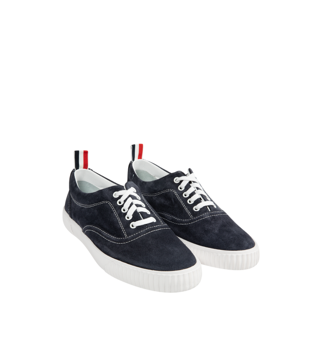 Image 2 of 5 - NAVY - THOM BROWNE Suede Heritage Trainer featuring lace up closure, rubber sole, leather lining and signature striped grosgrain loop tabs. Suede leather. Made in Italy.