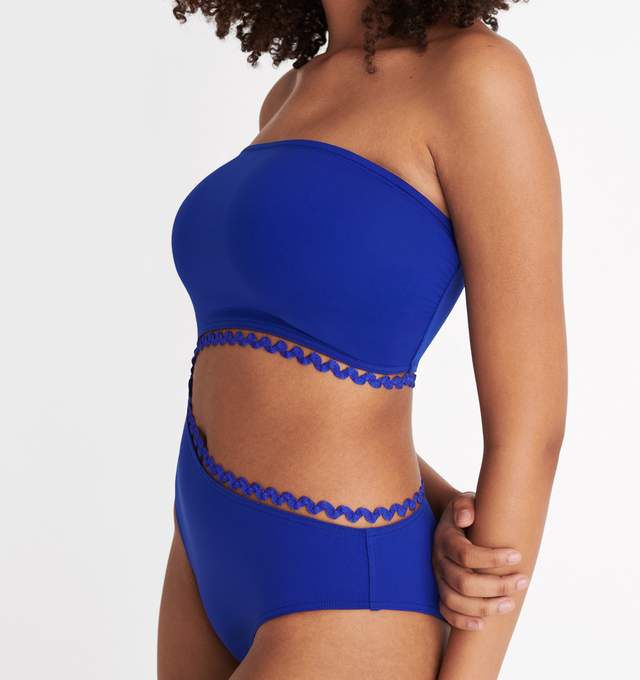 Image 6 of 6 - BLUE - ERES Dancing One-Piece Bustier Swimsuit featuring gripper tape, gathered sides and cutout on the left side underlined by a rick rack edge suspended by a nylon thread. Main: 84% Polyamid, 16% Spandex. Second: 93% Polyamid, 6% Spandex, 1% Polyester. Made in France.  