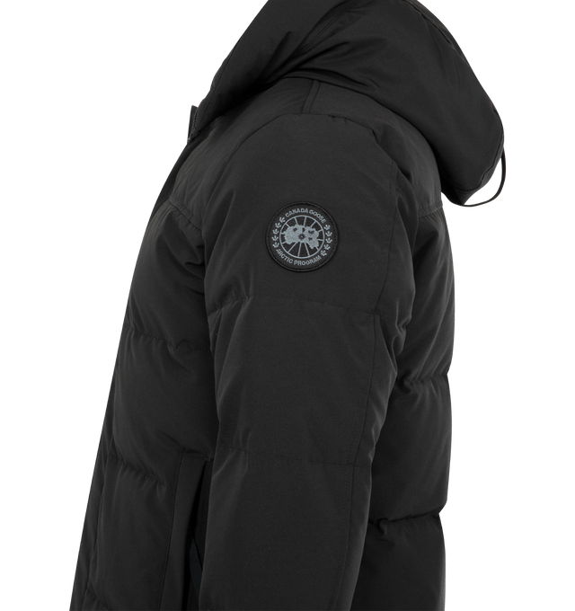 Image 3 of 3 - BLACK - CANADA GOOSE MacMillan Parka featuring adjustable down-filled Snorkel hood, hood features a removable zipper guard for the option of changing your hood trim for a customized look and added protection, chin guard is lined with tricot fabric, sleek interior hanging lining with backpack straps, placket with snap closures over 2-way zipper, storm flap underneath 2-way zipper, sleeve cuffs reinforced with CORDURA fabric, sip-length, cut longer in the back, 2 exterior fleece lined front poc