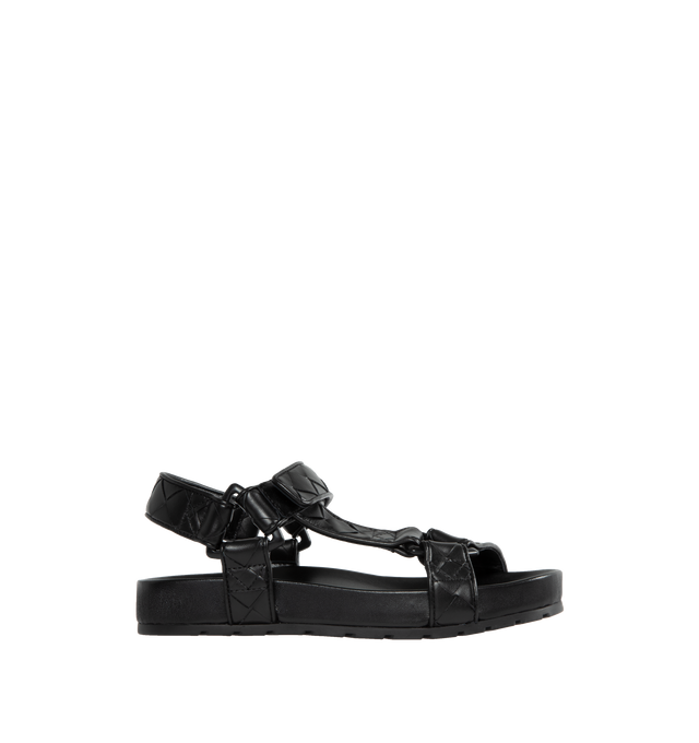 Image 1 of 4 - BLACK - BOTTEGA VENETA Leather Flat Sandals featuring ergonomic sculpted insole, round toe, VELCRO strap closure and signature intrecciato woven-pattern upper. Leather upper and lining, synthetic sole. Made in Italy. 