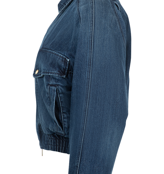 Image 4 of 4 - BLUE - Radh Women's The Ghillie Jacket is crafted from a regenerative cotton-blend denim fabric and features a structured jacket silhouette with a balance of utility and refined tailoring. Designed to layer comfortably over lightweight and heavier knits, this designer jacket offers a clean-lined shape with functional pockets and a textured finish that enhances its versatile appeal. Main Material: Regenerative Cotton Blend.