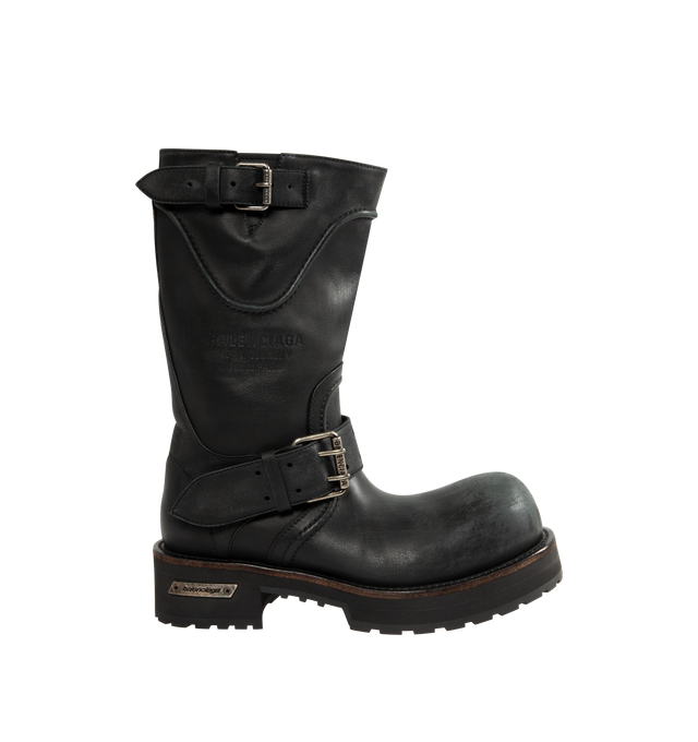 Image 1 of 4 - BLACK - BALENCIAGA Venom Boot featuring extra round toe, 20 mm arch, worn-out effect, adjustable straps with belt buckles, Balenciaga and 10 AV George V 75008 Paris logo debossed on the upper, plate with Balenciaga logo engraved on exterior outsole and thick toothed rubber outsole. Calfskin. Sole: micro, TPU, calfskin, zamac. Made in Italy.