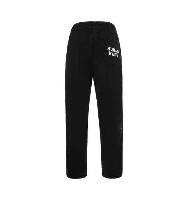 Image 2 of 4 - BLACK - HUMAN MADE Fleece Pants featuring a tapered silhouette, soft and comfortable polyester boa fleece, heart motif applique on the front, brand logo embroidered on the back pocket, line tape down the sides and side fasteners on the cuffs. 100% polyester.