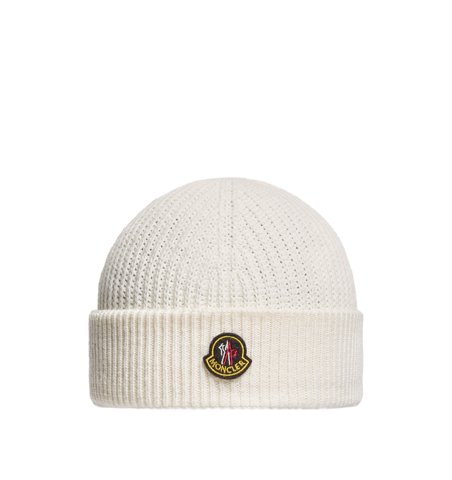 Image 1 of 1 - WHITE - Moncler Men's Wool and Cashmere Beanie is crafted from a luxurious wool and cashmere blend and features a textured half-brioche stitch knit for enhanced softness and dimension. Inspired by Moncler's mountain heritage, this cold-weather accessory is finished with a logo patch reminiscent of vintage alpine pins. Main Material: 90% Virgin Wool, 10% Cashmere.