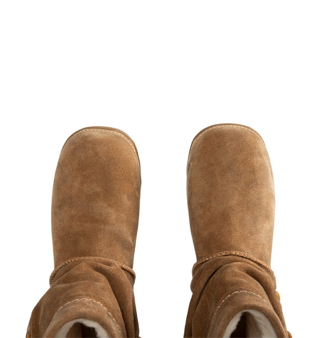 Image 4 of 4 - BROWN - UGG women's Bucked boot with a soft suede upper with an elevated, worn-in feel and a leather whipstitch detail, signature sheepskin lining and cushy rubber platform. Features sugarcane EVA midsole, molded rubber outsole and UGG Logo, heat-embossed.
