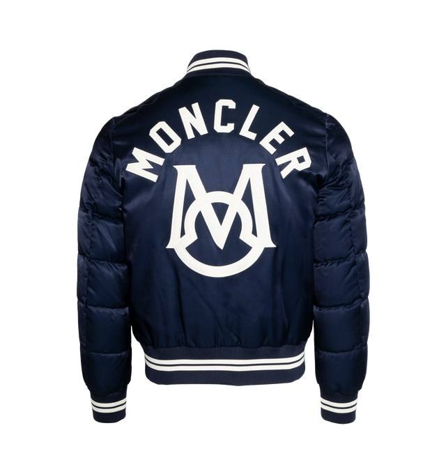 Image 2 of 3 - NAVY - MONCLER Dives Down Bomber Jacket featuring recycled longue saison lining, down-filled, embroidered logo lettering and logo, zipper and snap button closure, external pockets with snap button closure, zipped internal pocket and striped ribbed hem, collar and cuffs. Exterior: 58% cotton, 42% viscose/rayon. Lining: 100% polyamide/nylon. Padding: 90% down, 10% feather. Embroidery: 100% polyester. Ribs: 85% polyester, 13% polyamide/nylon, 2% elastane/spandex. Made in Romania. 