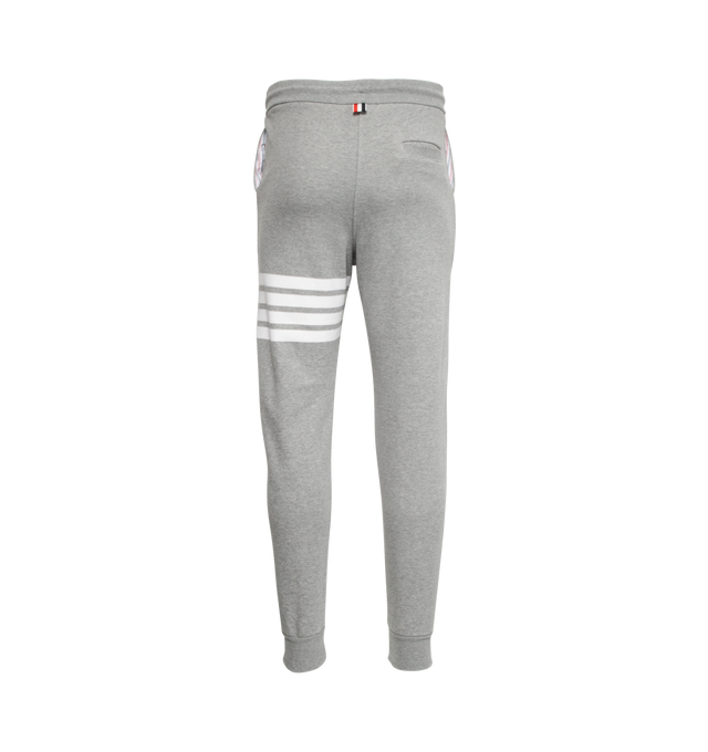 Image 2 of 5 - GREY - THOM BROWNE cotton jersey sweatpants with pull-on waist featuring drawcords, side pockets and slim leg with signature stripes, logo patch and cuffed hems.  
