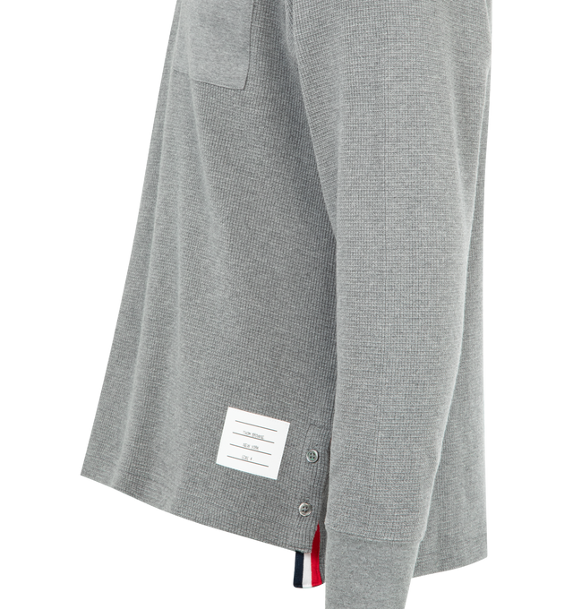 Image 3 of 3 - GREY - THOM BROWNE Waffle-Texture Rugby Polo Shirt featuring waffle knit cotton, signature name tag appliqu, point collar, concealed half placket, contrast chest pocket, ribbed cuffs, vented sides with striped grosgrain trim and pullover style. Cotton. Made in Japan.
