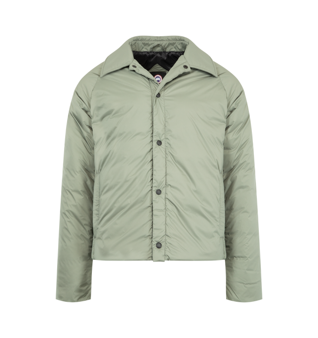 Image 1 of 3 - GREEN - CANADA GOOSE Lodge Coach Jacket featuring a pointed collar, packable into interior zip pocket, snap front closure, two exterior zippered pockets and two interior pockets: one drop-in pocket, one zippered security pocket. 100% nylon. Made in Canada.