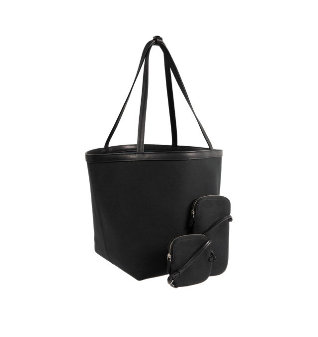 Image 2 of 3 - BLACK - THE ROW Park Tote Three Canvas Bag featuring classic tote bag in textured cotton twill with interior toggle closure, saddle leather trim and interior wristlet with adjustable strap. 85% cotton, 15% calfskin leather. Lined in 100% cotton. Made in Italy.