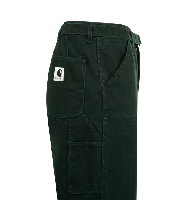 Image 3 of 3 - GREEN - SACAI X CARHARTT WIP Duck Cotton Pants featuring a cargo-inspired silhouette with double-knee, belted, side and back patch pockets, zip fly and button closure. 100% cotton. Made in Japan.