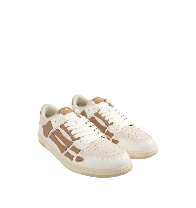 Image 2 of 5 - BROWN - AMIRI Skel Top Low Sneakers featuring low-top grained leather and cotton twill sneakers, perforations at toe, logo patch at padded tongue, padded collar, graphic appliqus at sides and logo printed at heel tab. Upper: leather, textile. Sole: rubber.