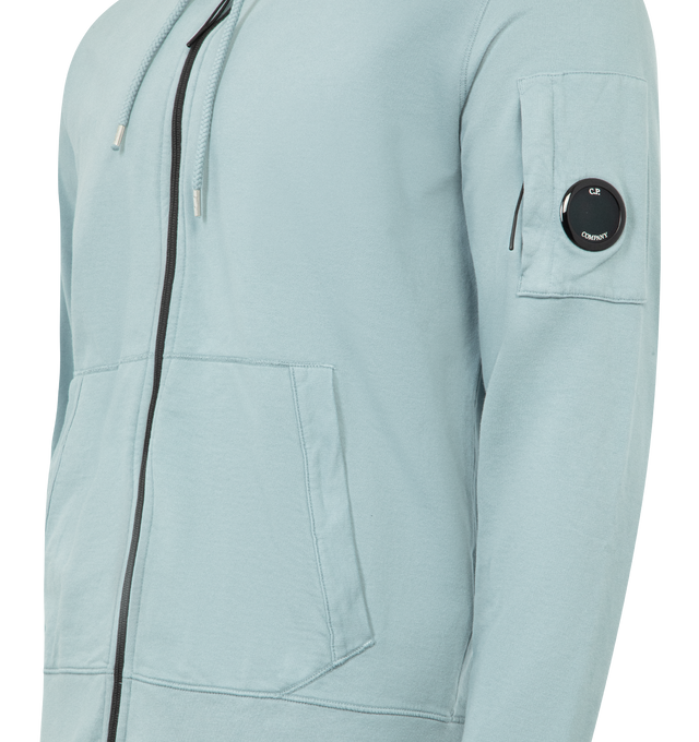 Image 3 of 3 - BLUE - C.P. COMPANY Light Fleece Zip Hooded Lens Sweatshirt featuring adjustable drawstring hood, full zip fastening, lens detail, kangaroo pocket, ribbed cuffs and hem, garment dyed and regular fit. 100% cotton. Made in Italy.