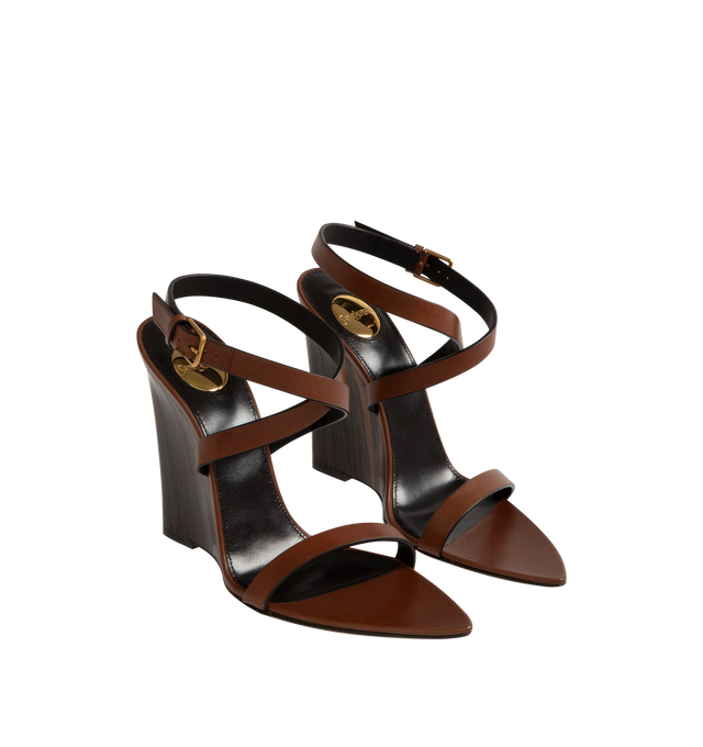 Image 2 of 4 - BROWN - SAINT LAURENT Gippy Wedge Sandal featuring ankle buckle closure, pointed toe and wedge heel. 4.3 inch wedge. Leather upper and sole. Made in Italy.