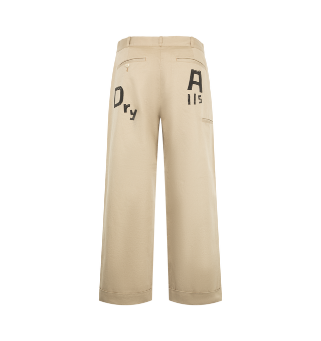 Image 2 of 3 - NEUTRAL - Human Made Men's Wide Fit Chino Pants are crafted from high-density cotton chino cloth and feature a wide-leg silhouette with a high-rise waist and relaxed fit. Designed with a crisp handfeel and subtle sheen, these statement trousers are detailed with hand-painted-style graphic artwork, a printed brand message inside the back waistband, and a signature heart-shaped button at the back left pocket. Main Material: 100% Cotton.