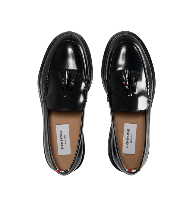 Image 4 of 4 - NAVY - THOM BROWNE Spazzolato Leather Tassle Loafer featuring classic penny loafers with red, white, and blue trim at the tassels, slip on and signature striped grosgrain loop tabs at heels 100% calf leather. Sole: 100% rubber. Lining: 100% calf leather. Made in Italy.