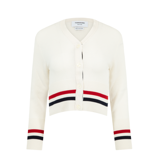 Image 1 of 3 - WHITE - THOM BROWNE Cashmere RWB Stripe Shrunken Cardigan featuring V-neckline, rront button closure, ribbed buttoned cuffs with RWB grosgrain trim, buttoned side vents with RWB grosgrain trim, ribbed hem, knit RWB tipping at cuffs and hem, signature striped grosgrain loop tab and shrunken fit. 100% cashmere. Made in the United Kingdom.