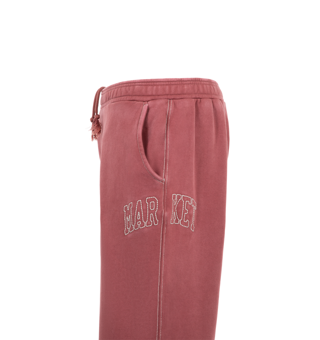 Image 3 of 3 - RED - Market Men's Big Stitch Open Leg Sweatpants are crafted from heavyweight cotton fleece and feature a relaxed open-leg silhouette with oversized contrast stitching, an elasticated drawstring waistband, side pockets, and a back pocket for everyday functionality. These designer sweatpants combine premium comfort with Market's signature contemporary streetwear aesthetic, creating an elevated essential for casual wear. Main Material: 100% Cotton.