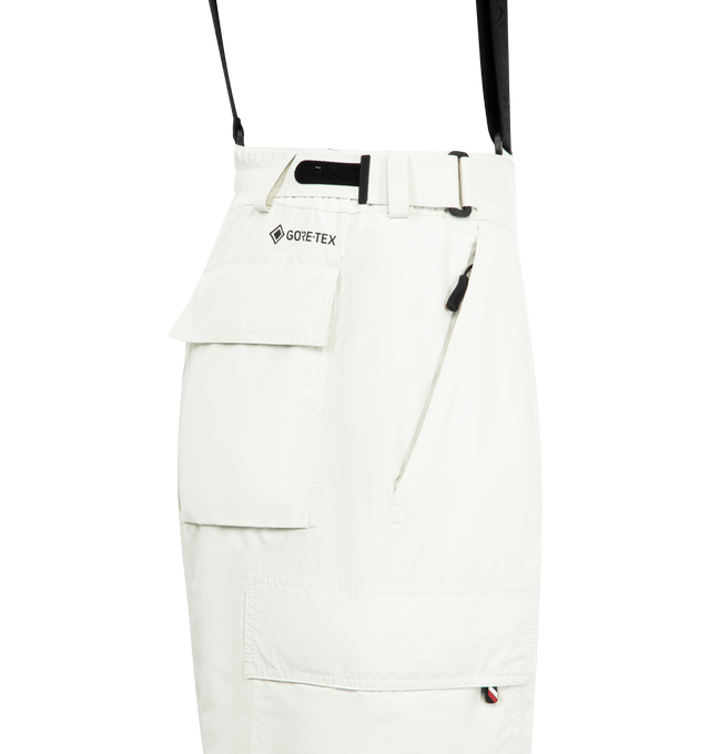 Image 3 of 3 - WHITE - MONCLER GRENOBLE GORE-TEX Laminate Padded Ski Bib featuring 2L GORE-TEX laminate, stretch technical polyester lining, Primaloft Active Insulation, heat-sealed seams, adjustable suspenders, YKK AquaGuard Highly Water Resistant zipper and snap button closure, pockets with YKK AquaGuard Highly Water Resistant and strap closure, powder cuffs, ski cut hem protection, RECCO reflector and silicone logo patch. 100% polyester.