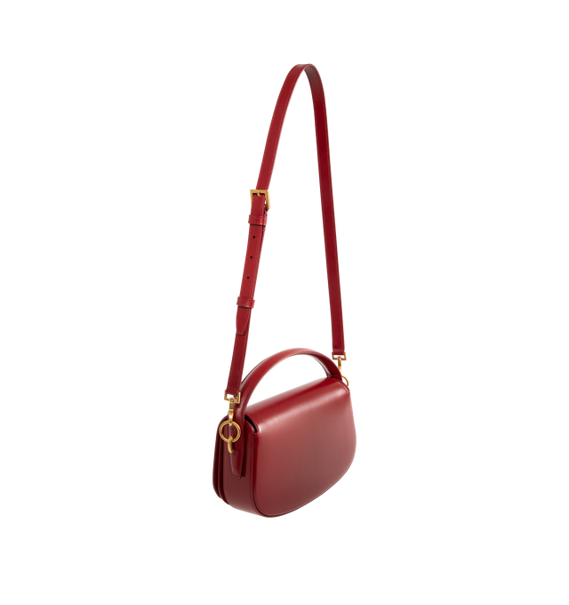 Image 2 of 3 - RED - SAINT LAURENT Voltaire Box Bag featuring half-moon shoulder bag in calfskin with a gently polished finish, flap with pivoting cassandre closure, an adjustable and detachable swivel-hook strap, leather lining, bronze-toned hardware and one flat pocket. 9.4" x 5.9" x 2". Handle drop: 2.4". Strap drop: 10.6". Calfskin leather. Made in Italy.