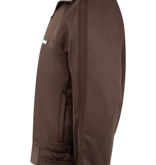 Image 3 of 3 - BROWN - RHUDE Madera Track Jacket featuring funnel neck, long sleeves, 2-way zip, 2 waist welt pockets and regular fit. 100% polyester.